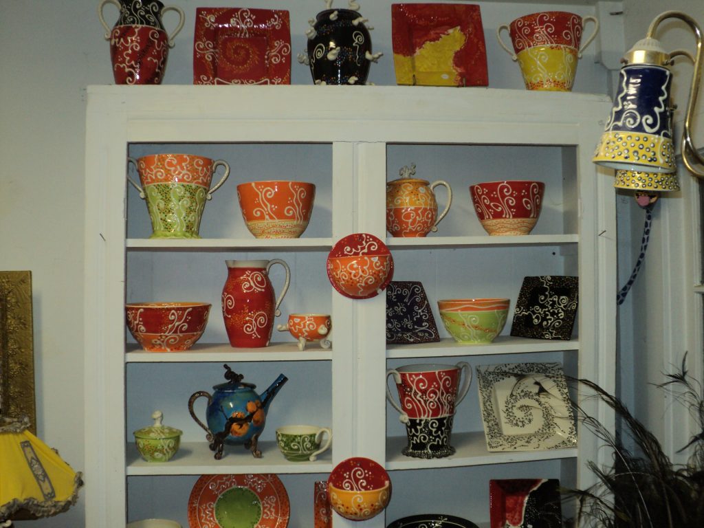 Upper part of the orange/chartreuse/red and black cupboard.